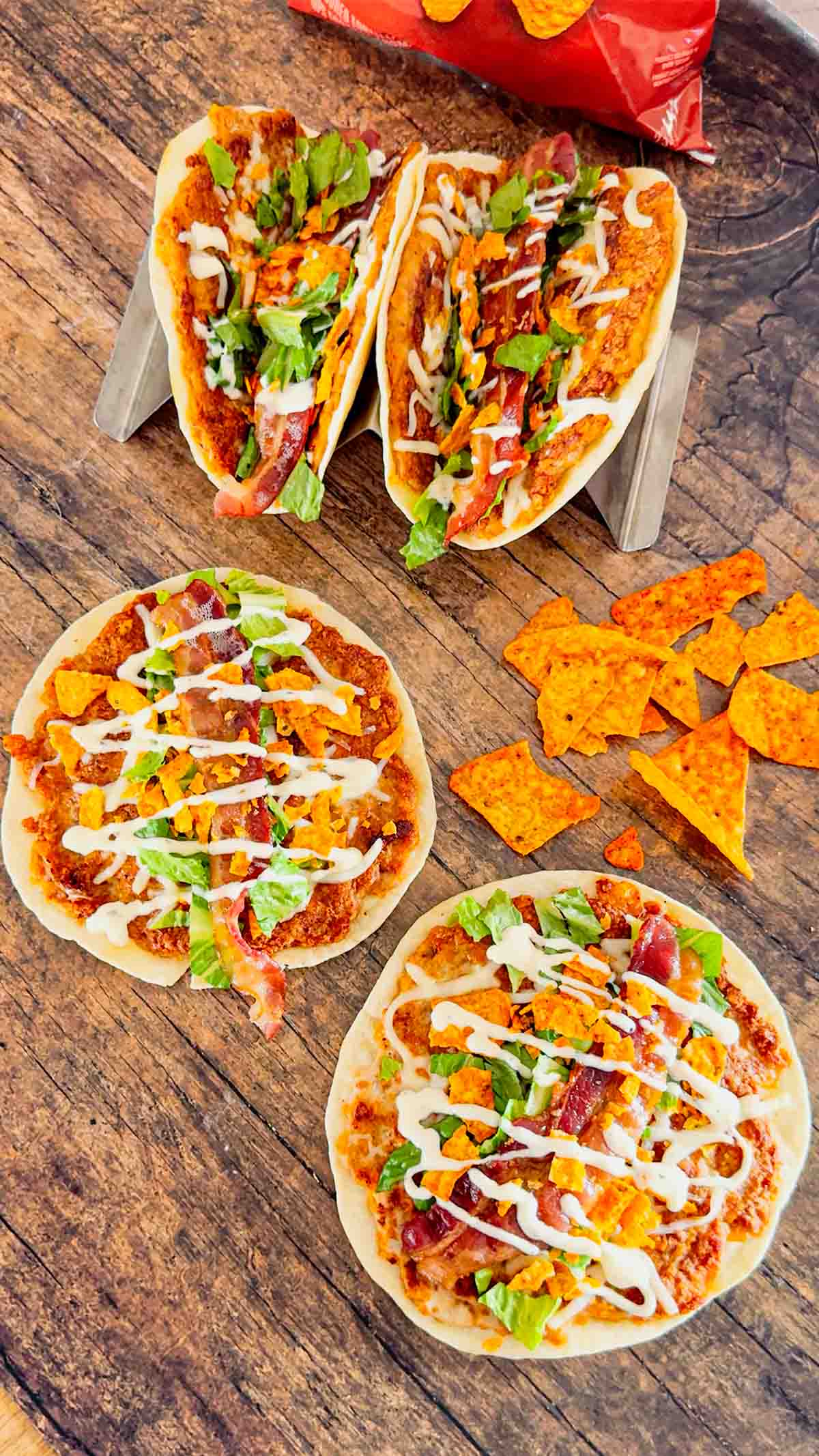 Doritos Crusted Chicken Smash Tacos are a fun twist on smash burger tacos. Flour tortillas are spread with a ground chicken and crushed Doritos mixture and fried until crispy before being topped with shredded mozzarella, chopped lettuce, crispy bacon, ranch dressing and more Doritos.