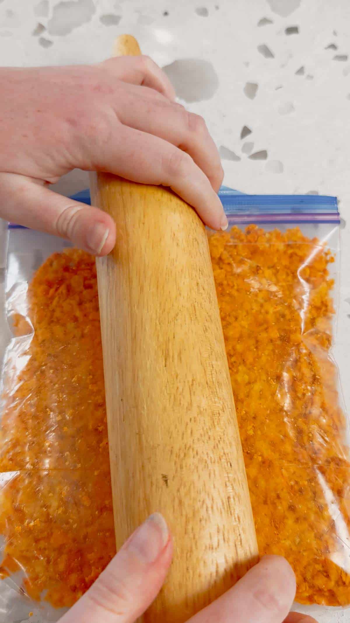 rolling pin crushing doritos in a ziploc bag