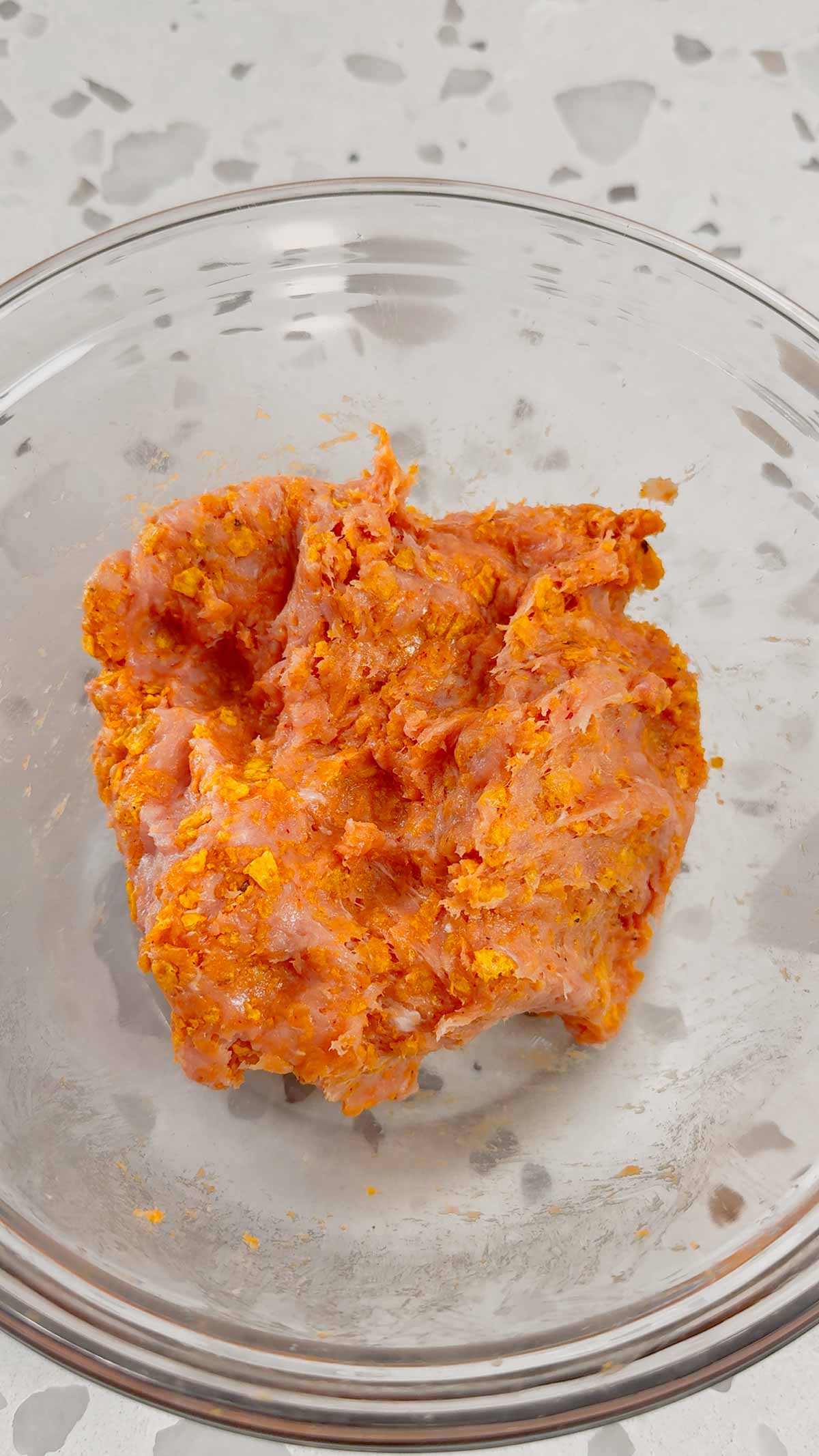 ground chicken and crushed doritos mixture in a mixing bowl