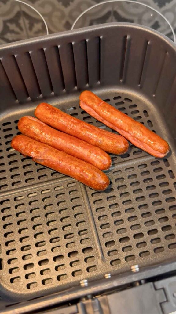 cooked wieners in an air fryer basket