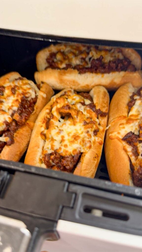 cooked sloppy joe dogs in an air fryer basket