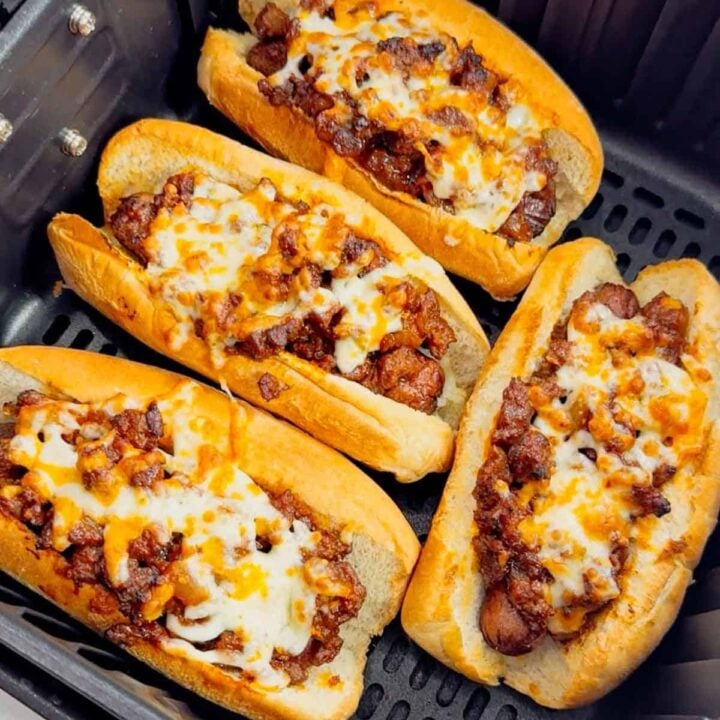 Air Fryer Sloppy Joe Dogs are a fun and easy recipe perfect for lunches or weeknight dinners. These tasty hot dogs are loaded with a homemade ground beef sloppy joe mixture and shredded cheese and air fried until perfectly toasted.