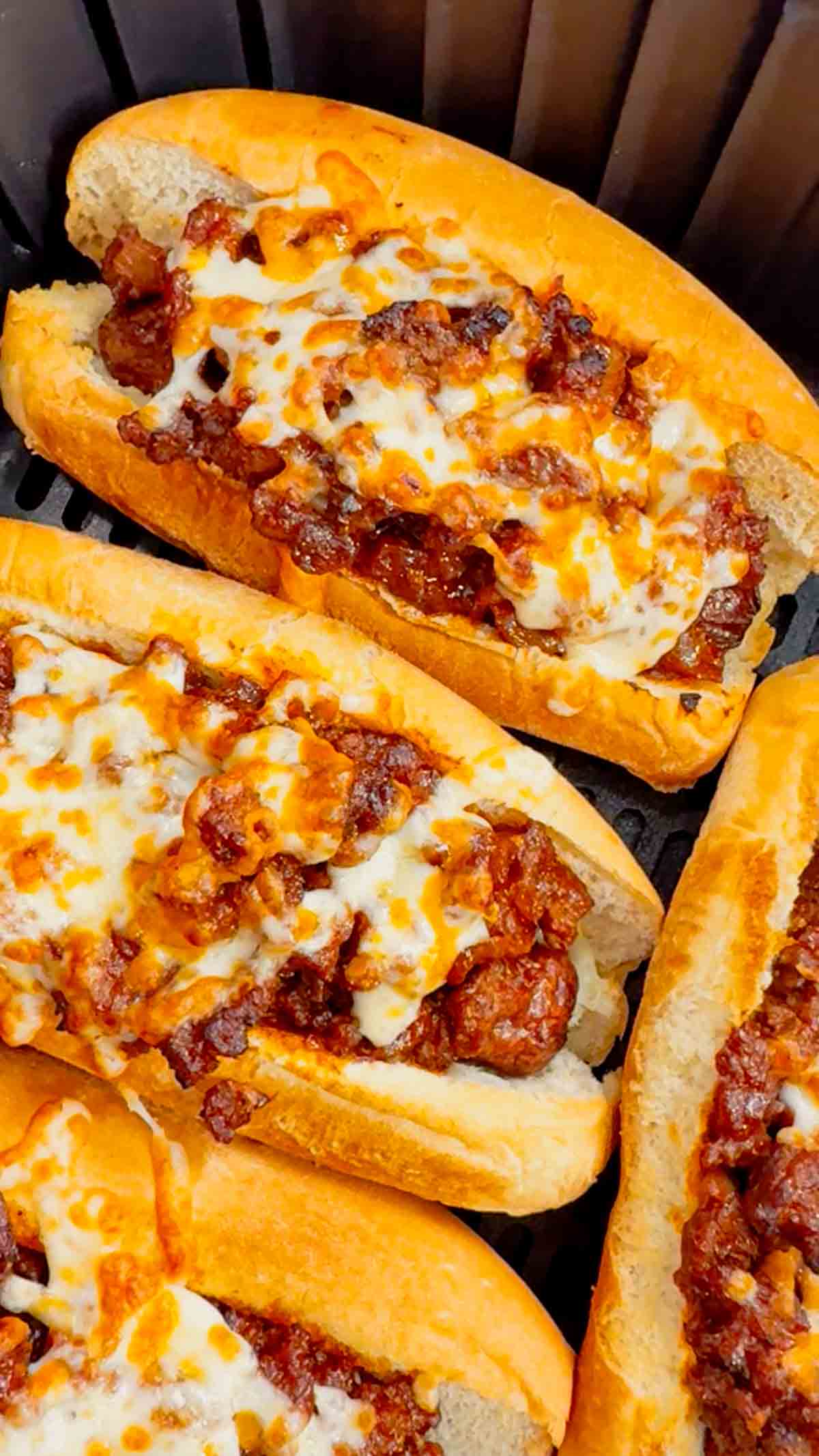 Air Fryer Sloppy Joe Dogs are a fun and easy recipe perfect for lunches or weeknight dinners. These tasty hot dogs are loaded with a homemade ground beef sloppy joe mixture and shredded cheese and air fried until perfectly toasted.