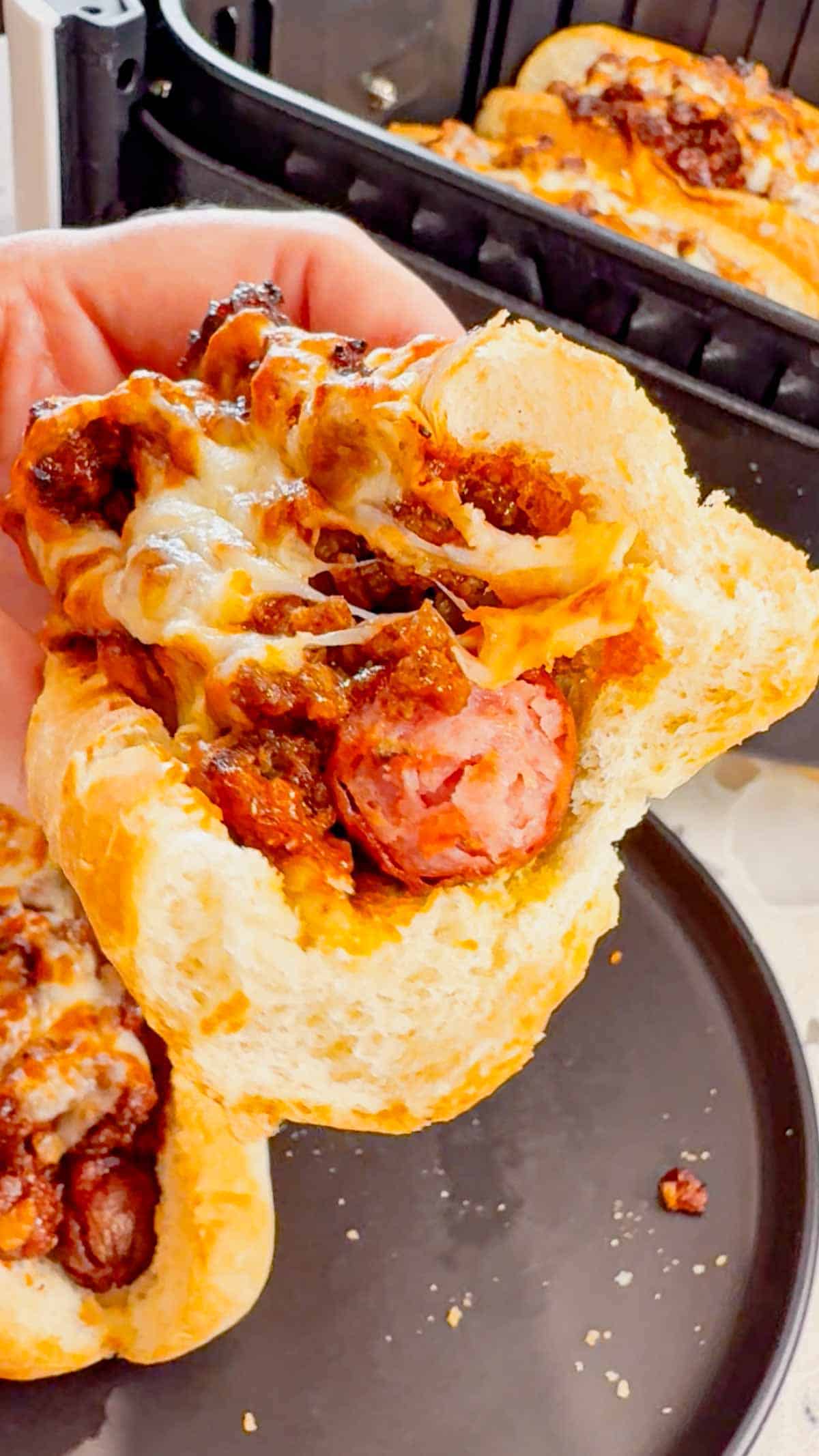 Air Fryer Sloppy Joe Dogs are a fun and easy recipe perfect for lunches or weeknight dinners. These tasty hot dogs are loaded with a homemade ground beef sloppy joe mixture and shredded cheese and air fried until perfectly toasted.