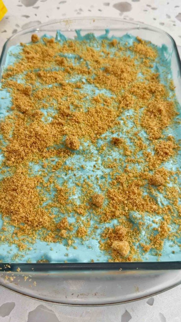 graham cracker crumbs on top of blue pudding dirt cake