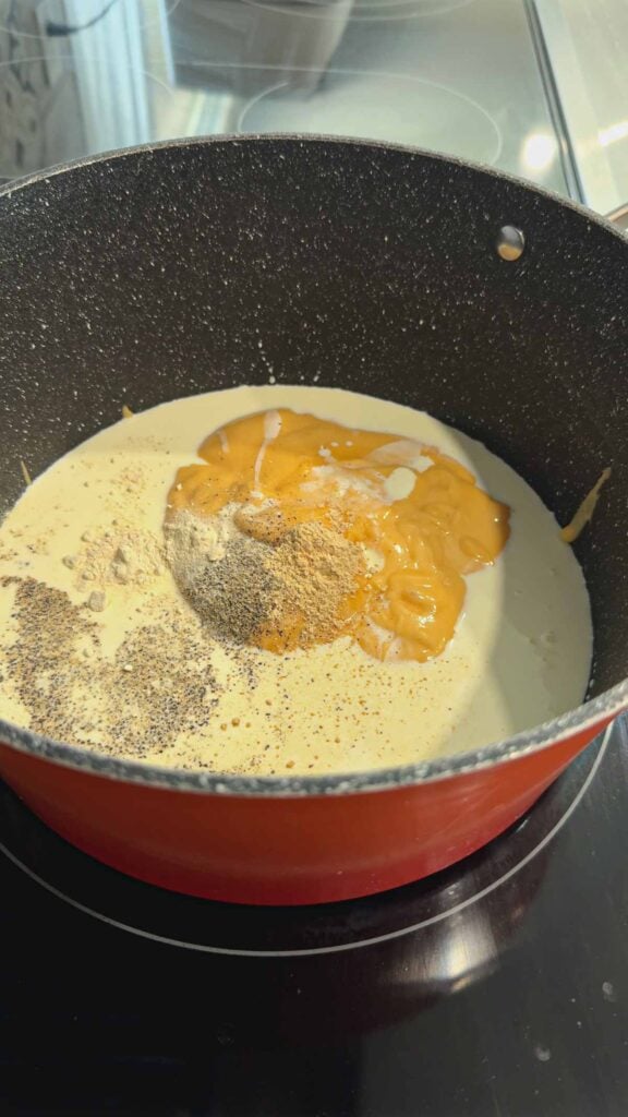 heavy cream, cheddar soup and spices in a large pot