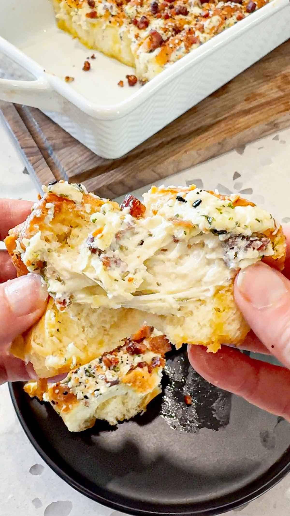 Everything Bacon Cheesy Hawaiian Roll Garlic Bread is the perfect party food or dinner side dish. King's Hawaiian Rolls are sliced and stuffed with herb and garlic cream cheese, crumbled bacon and shredded mozzarella cheese, brushed with garlic butter and topped with everything bagel seasoning before being baked to melty perfection.