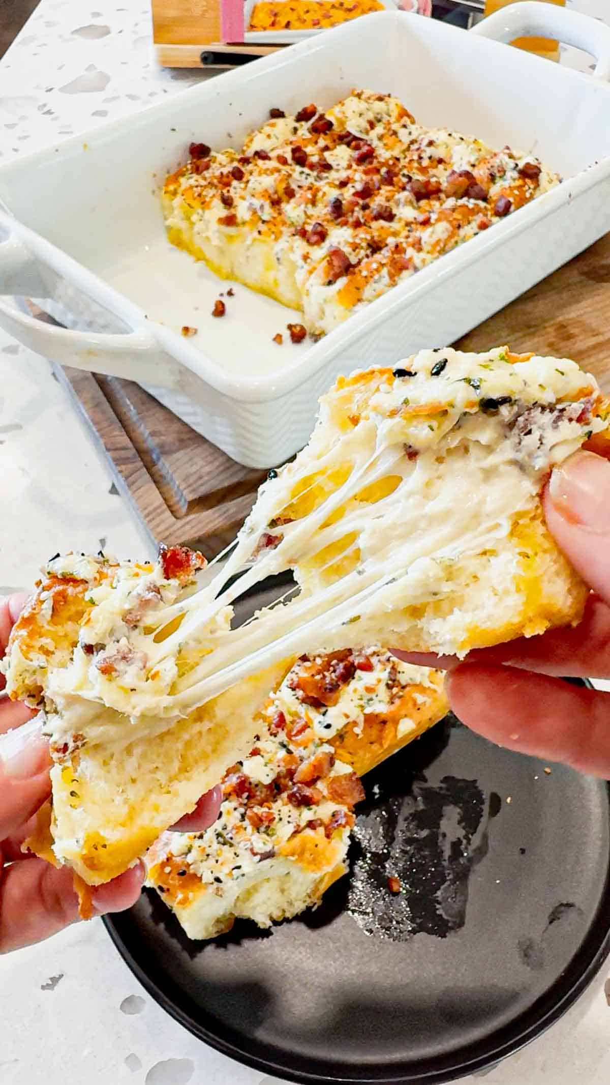 Everything Bacon Cheesy Hawaiian Roll Garlic Bread is the perfect party food or dinner side dish. King's Hawaiian Rolls are sliced and stuffed with herb and garlic cream cheese, crumbled bacon and shredded mozzarella cheese, brushed with garlic butter and topped with everything bagel seasoning before being baked to melty perfection.