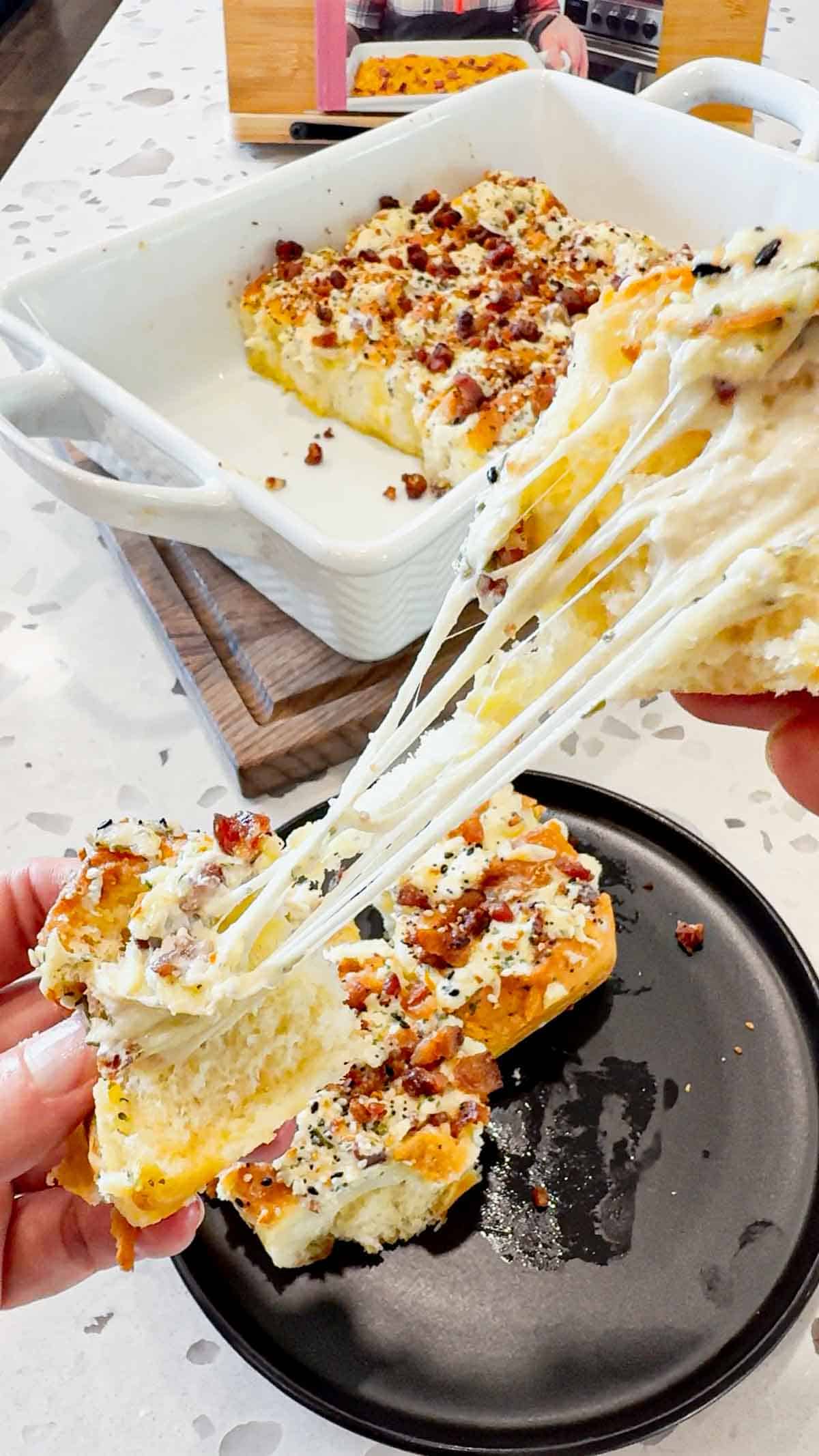 Everything Bacon Cheesy Hawaiian Roll Garlic Bread is the perfect party food or dinner side dish. King's Hawaiian Rolls are sliced and stuffed with herb and garlic cream cheese, crumbled bacon and shredded mozzarella cheese, brushed with garlic butter and topped with everything bagel seasoning before being baked to melty perfection.