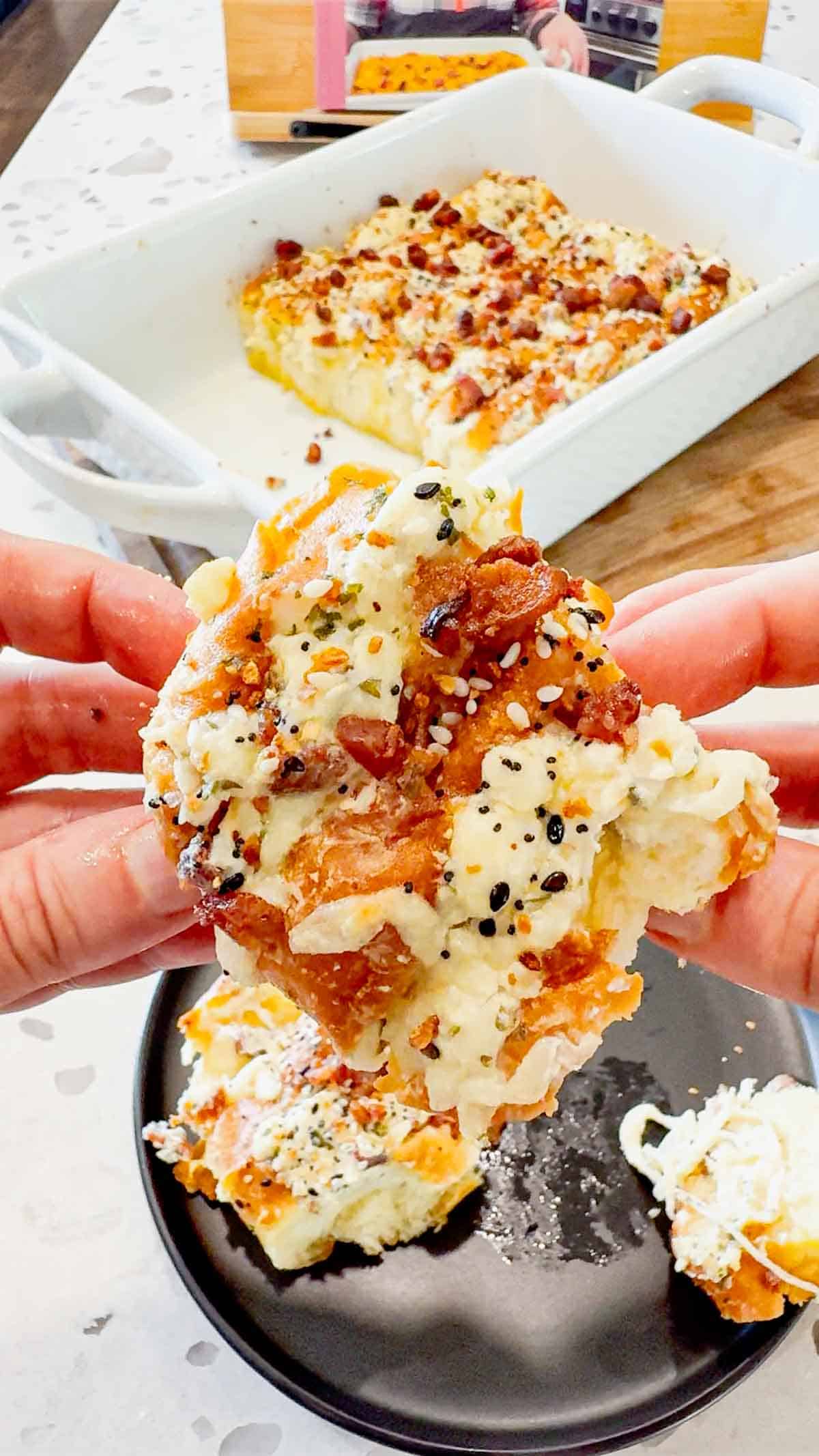Everything Bacon Cheesy Hawaiian Roll Garlic Bread is the perfect party food or dinner side dish. King's Hawaiian Rolls are sliced and stuffed with herb and garlic cream cheese, crumbled bacon and shredded mozzarella cheese, brushed with garlic butter and topped with everything bagel seasoning before being baked to melty perfection.