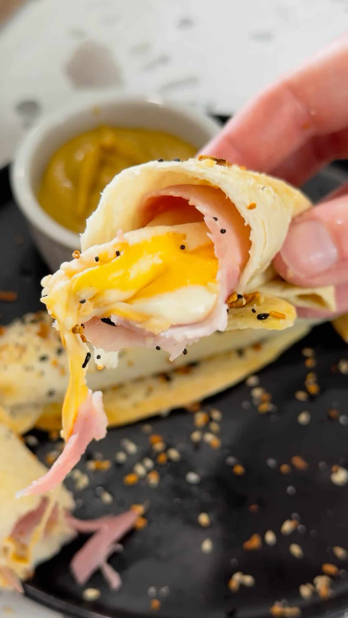 Air Fryer Ham and Cheese Sticks are an easy snack perfect for a quick lunch or party food. Ham and string cheese are rolled up inside flour tortillas, brushed with melted butter and topped with everything bagel seasoning before being toasted to perfection in an air fryer.