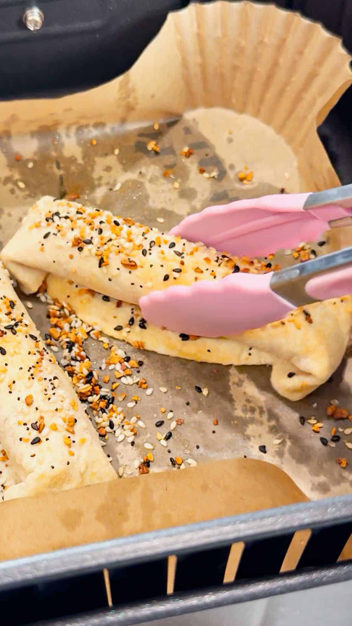 Air Fryer Ham and Cheese Sticks are an easy snack perfect for a quick lunch or party food. Ham and string cheese are rolled up inside flour tortillas, brushed with melted butter and topped with everything bagel seasoning before being toasted to perfection in an air fryer.