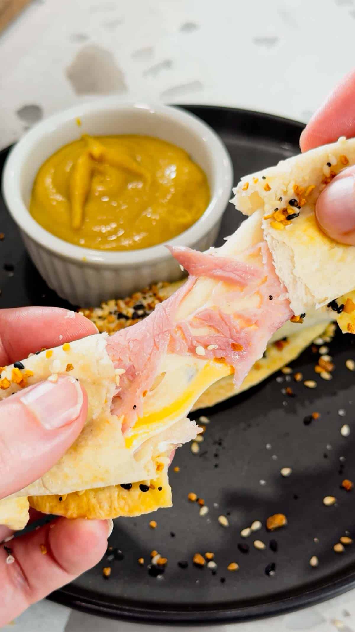 Air Fryer Ham and Cheese Sticks are an easy snack perfect for a quick lunch or party food. Ham and string cheese are rolled up inside flour tortillas, brushed with melted butter and topped with everything bagel seasoning before being toasted to perfection in an air fryer.