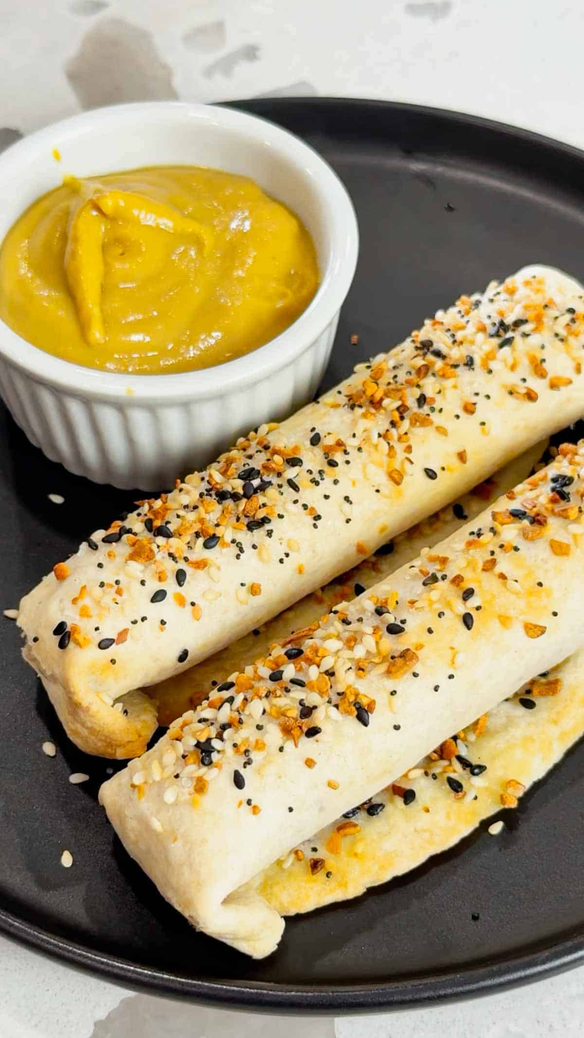 Air Fryer Ham and Cheese Sticks are an easy snack perfect for a quick lunch or party food. Ham and string cheese are rolled up inside flour tortillas, brushed with melted butter and topped with everything bagel seasoning before being toasted to perfection in an air fryer.