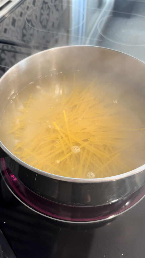linguine noodles cooking in a pot of boiling water
