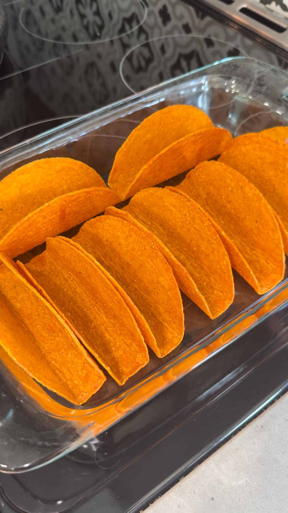 cheesy blasted stand and stuff taco shells in a glass baking dish