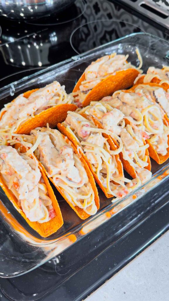 chicken alfredo pasta stuffed into cheesy blasted taco shells