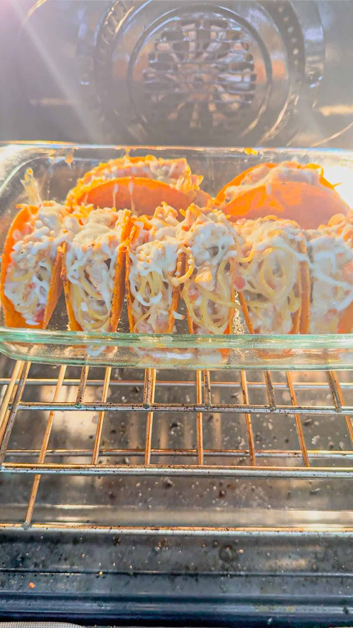 chicken alfredo tacos baking in the oven