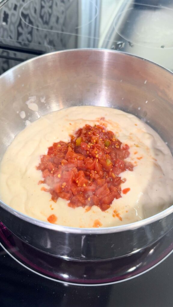 Rotel diced tomatoes added to pot with alfredo sauce.