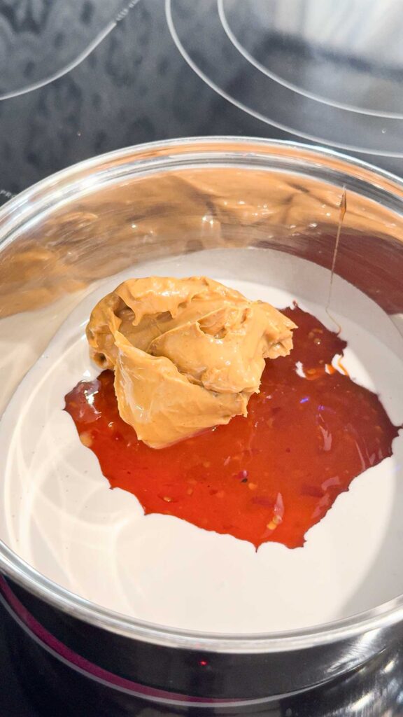 peanut butter, sweet chili Thai sauce and coconut milk in a pot