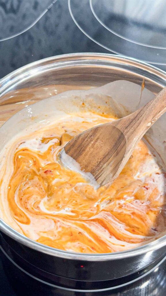 coconut milk, peanut butter and sweet chili Thai sauce in a pot