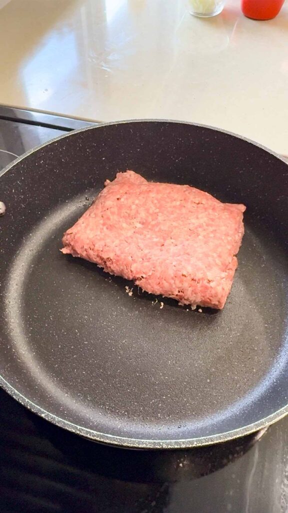 raw ground beef in a skillet