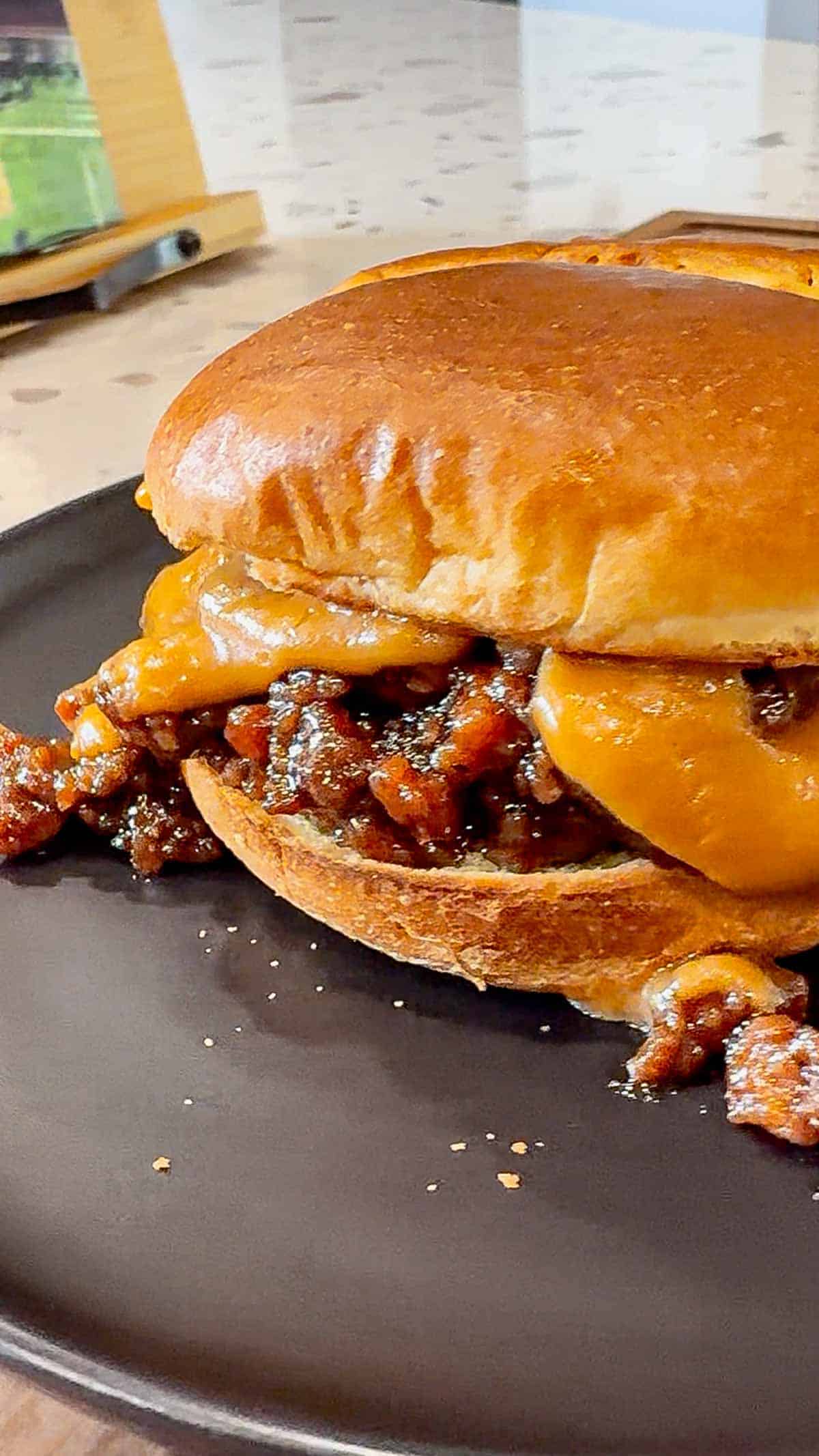Peanut Butter and Jelly Sloppy Joes are a fun twist on a classic family dinner recipe. These tasty sandwiches are loaded with ground beef tossed in a strawberry jam and bbq sauce mixture and topped with a coconut milk peanut butter sauce with a bit of a kick from some Thai sweet chili sauce.