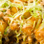 Big Mac Tater Tot Casserole is an easy weeknight dinner recipe idea that is super kid friendly. This ground beef and potato casserole has all the flavours of you favourite fast food sandwich. It starts with a base of ground beef, diced onions and dill pickles and is topped with cheese, tater tots, lettuce and copycat big mac sauce.