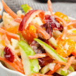 Carrot Apple Salad is a delicious and colourful salad loaded with sliced red and green apples, carrots, dried cranberries and mandarins all tossed in a vanilla yogurt and mayo dressing. This festive side dish is perfect for holiday dinners like Thanksgiving and Christmas as well as summer potlucks