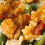 Cream Cheese and Bacon Green Bean Casserole is a classic holiday dinner side dish recipe. This creamy green bean casserole is perfect for Thanksgiving and Christmas. This dish is loaded with frozen cut green beans, cream cheese, onion soup mix, and crumbled bacon all topped with crispy fried onions and Ritz cracker crumbs.