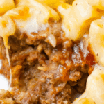 Mac and Cheese Meatloaf Casserole is a fun mashup of two classic comfort food meals. This fun dinner idea starts with a ground beef meatloaf base topped with a ketchup meatloaf glaze followed by a top layer of creamy macaroni and cheese. This is a family friendly dinner recipe the kids will love.