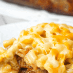 Mac and Cheese Meatloaf Casserole is a fun mashup of two classic comfort food meals. This fun dinner idea starts with a ground beef meatloaf base topped with a ketchup meatloaf glaze followed by a top layer of creamy macaroni and cheese. This is a family friendly dinner recipe the kids will love.