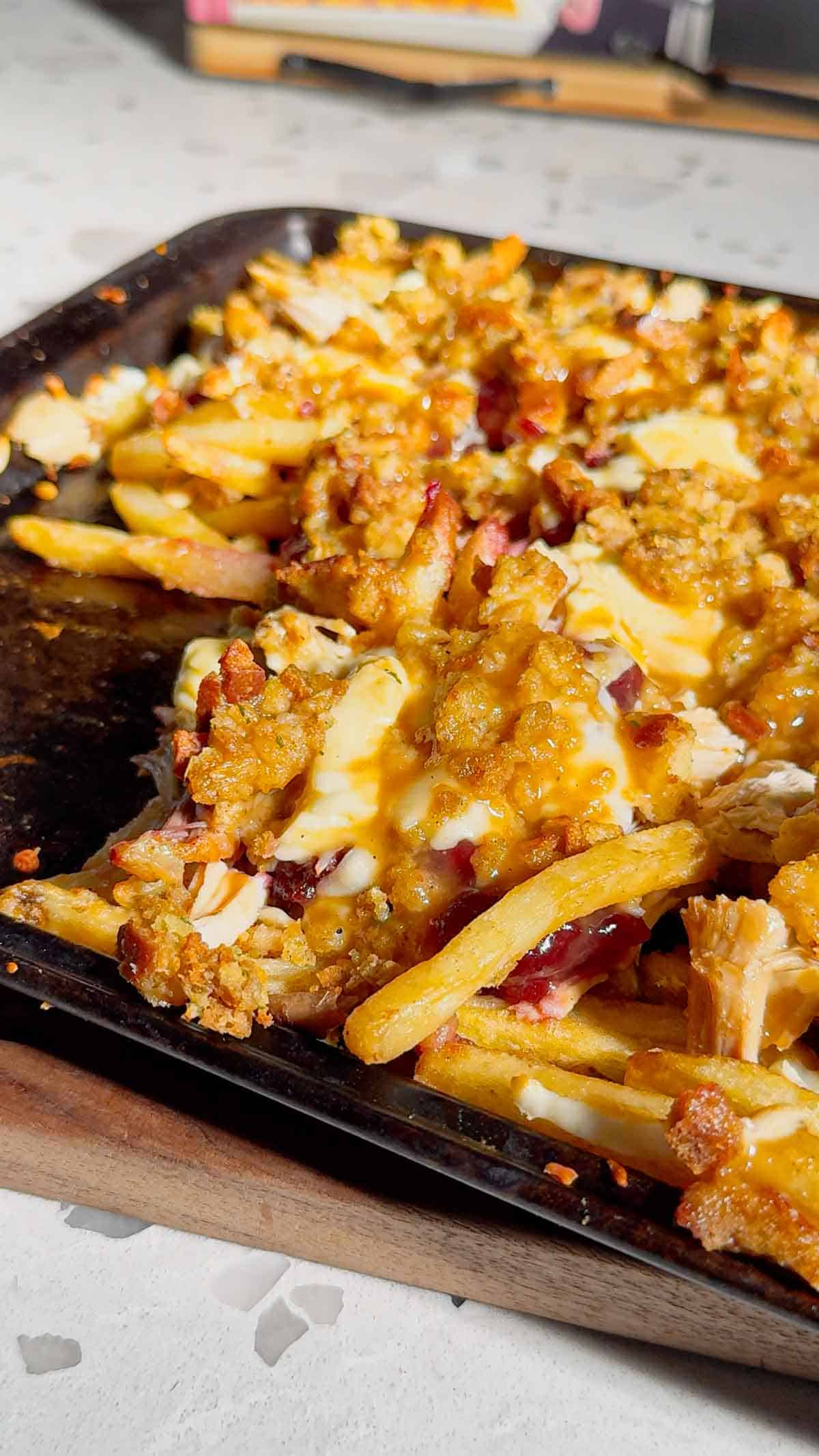 Turn your Thanksgiving leftovers into the ultimate comfort food with this Sheet Pan Thanksgiving Poutine! Crispy french fries loaded with shredded turkey, cheese curds, mozzarella, stuffing, cranberry sauce, and plenty of rich gravy. It’s easy, melty, over-the-top delicious, and the perfect way to reinvent holiday leftovers. Save this recipe for your post-Thanksgiving cravings!