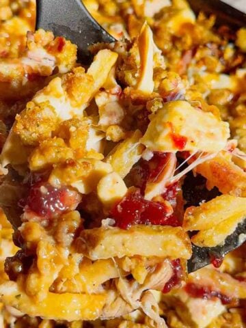 Turn your Thanksgiving leftovers into the ultimate comfort food with this Sheet Pan Thanksgiving Poutine! Crispy french fries loaded with shredded turkey, cheese curds, mozzarella, stuffing, cranberry sauce, and plenty of rich gravy. It’s easy, melty, over-the-top delicious, and the perfect way to reinvent holiday leftovers. Save this recipe for your post-Thanksgiving cravings!