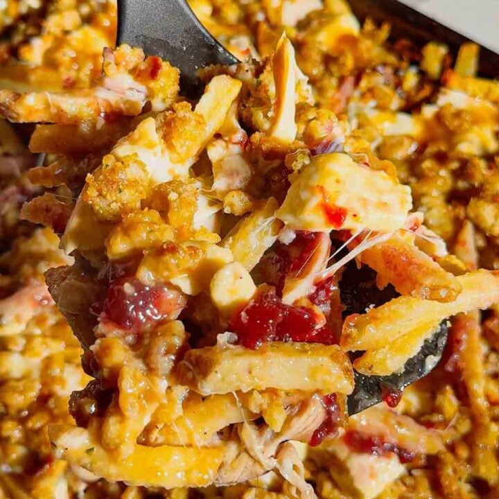 Turn your Thanksgiving leftovers into the ultimate comfort food with this Sheet Pan Thanksgiving Poutine! Crispy french fries loaded with shredded turkey, cheese curds, mozzarella, stuffing, cranberry sauce, and plenty of rich gravy. It’s easy, melty, over-the-top delicious, and the perfect way to reinvent holiday leftovers. Save this recipe for your post-Thanksgiving cravings!