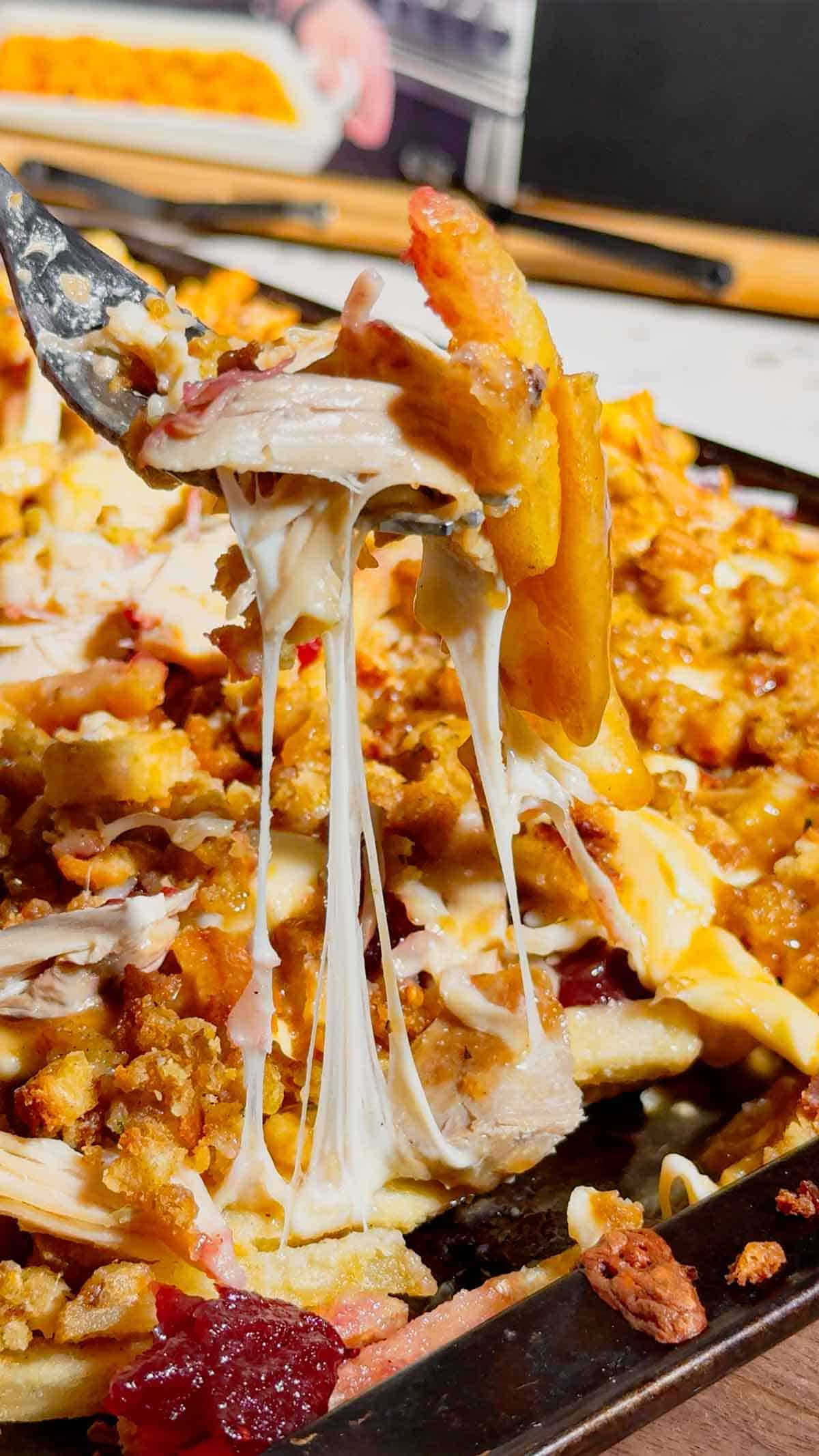 Turn your Thanksgiving leftovers into the ultimate comfort food with this Sheet Pan Thanksgiving Poutine! Crispy french fries loaded with shredded turkey, cheese curds, mozzarella, stuffing, cranberry sauce, and plenty of rich gravy. It’s easy, melty, over-the-top delicious, and the perfect way to reinvent holiday leftovers. Save this recipe for your post-Thanksgiving cravings!