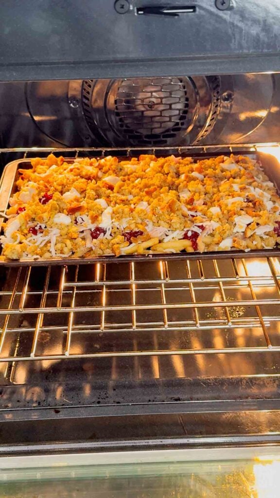 thanksgiving poutine on a baking sheet in the oven