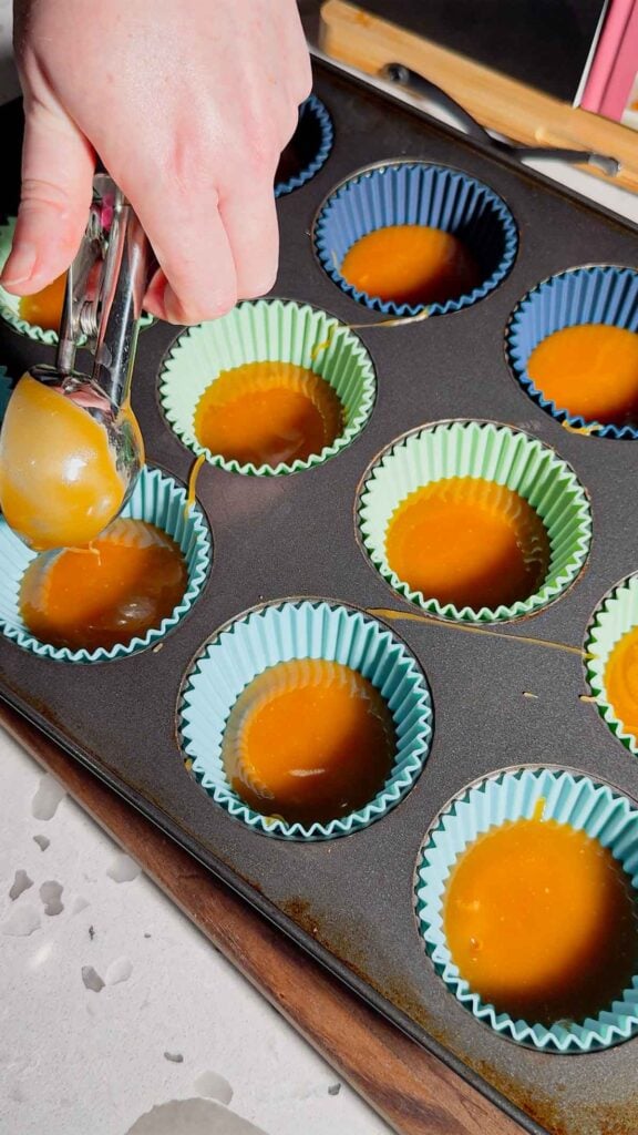 spoon melted butter and brown sugar toffee mixture over peanut butter ritz cracker sandiwches in muffin tins