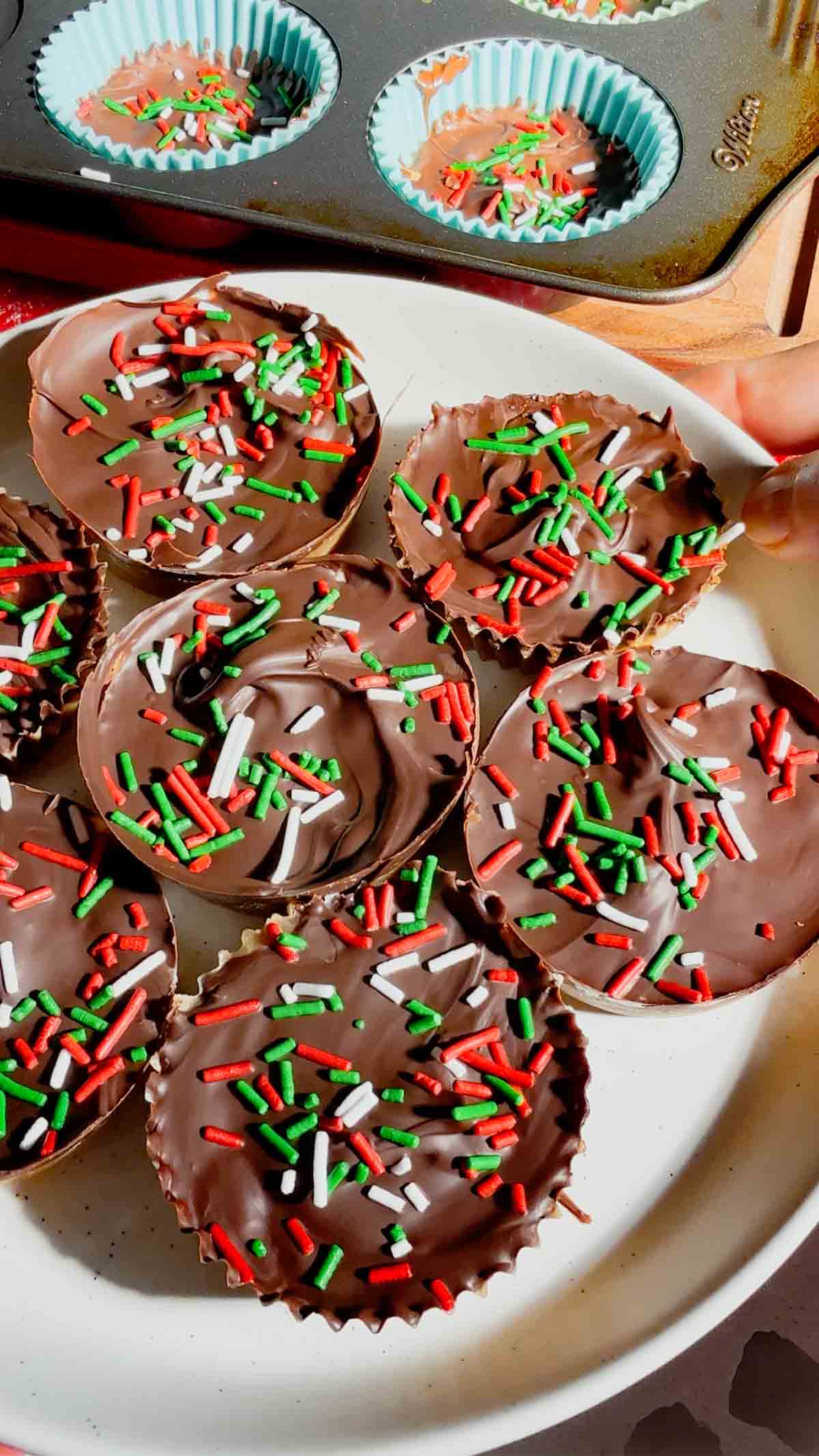 Get ready for the ultimate sweet-and-salty holiday treat with these Peanut Butter Ritz Crack Christmas Crack Cookies! Made in muffin tins, this fun twist on classic Christmas crack uses Peanut Butter Ritz Cracker Snackwiches smothered in rich, buttery toffee, topped with melted semi-sweet chocolate, and finished with festive sprinkles. Easy to make, irresistibly crunchy, and perfectly portioned, these holiday cookies are guaranteed to disappear fast at parties, on cookie trays, or as edible gifts.