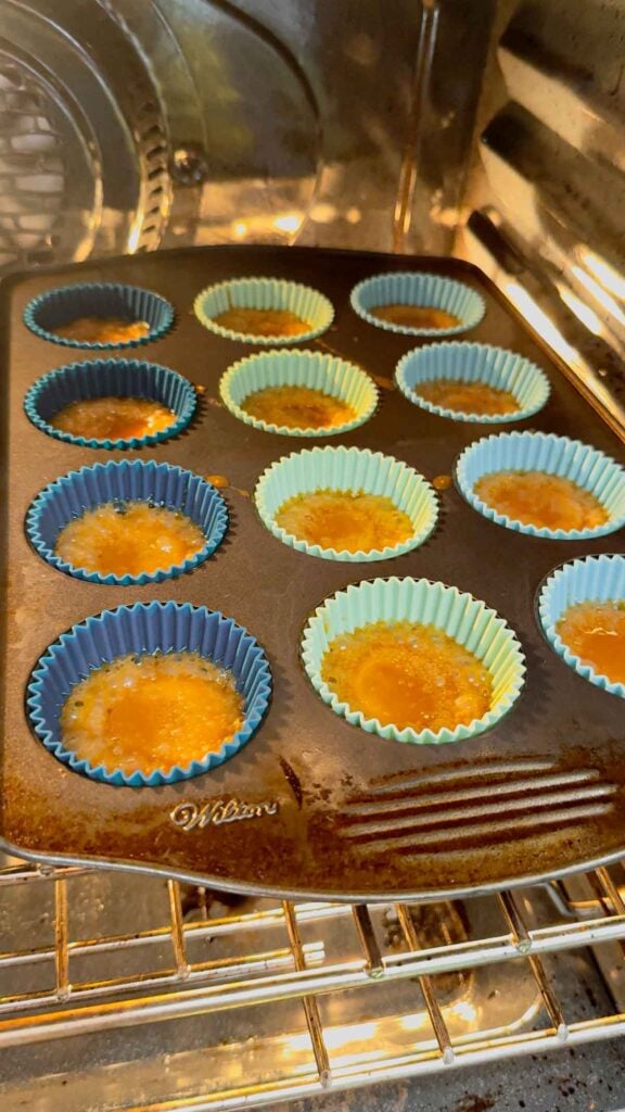 ritz cracker christmas crack bubbling in muffin tins in the oven