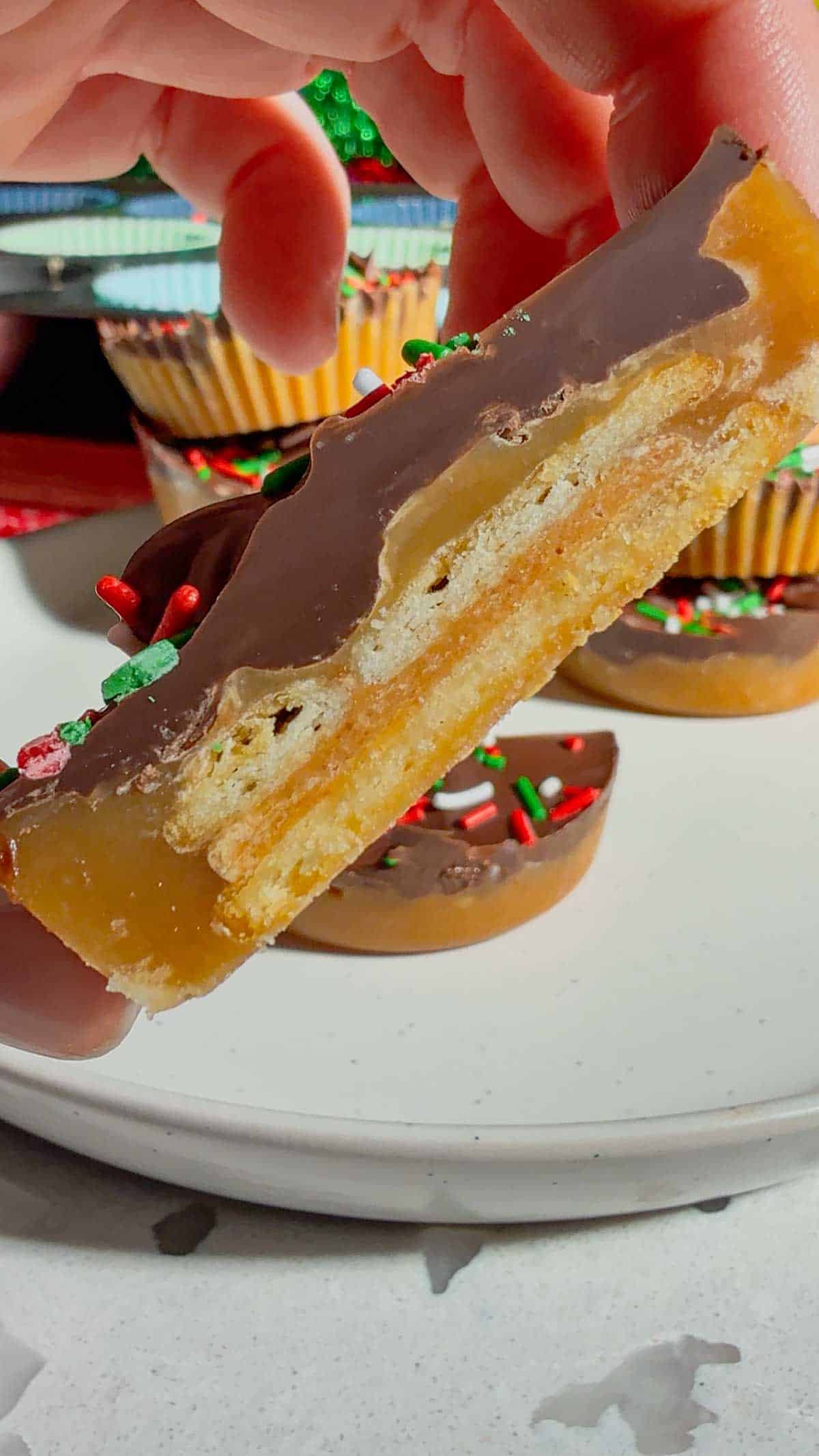 Get ready for the ultimate sweet-and-salty holiday treat with these Peanut Butter Ritz Crack Christmas Crack Cookies! Made in muffin tins, this fun twist on classic Christmas crack uses Peanut Butter Ritz Cracker Snackwiches smothered in rich, buttery toffee, topped with melted semi-sweet chocolate, and finished with festive sprinkles. Easy to make, irresistibly crunchy, and perfectly portioned, these holiday cookies are guaranteed to disappear fast at parties, on cookie trays, or as edible gifts.