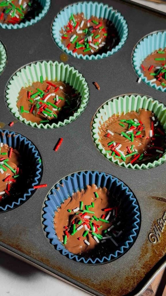 sprinkles on top of ritz cracker toffee in muffin cups