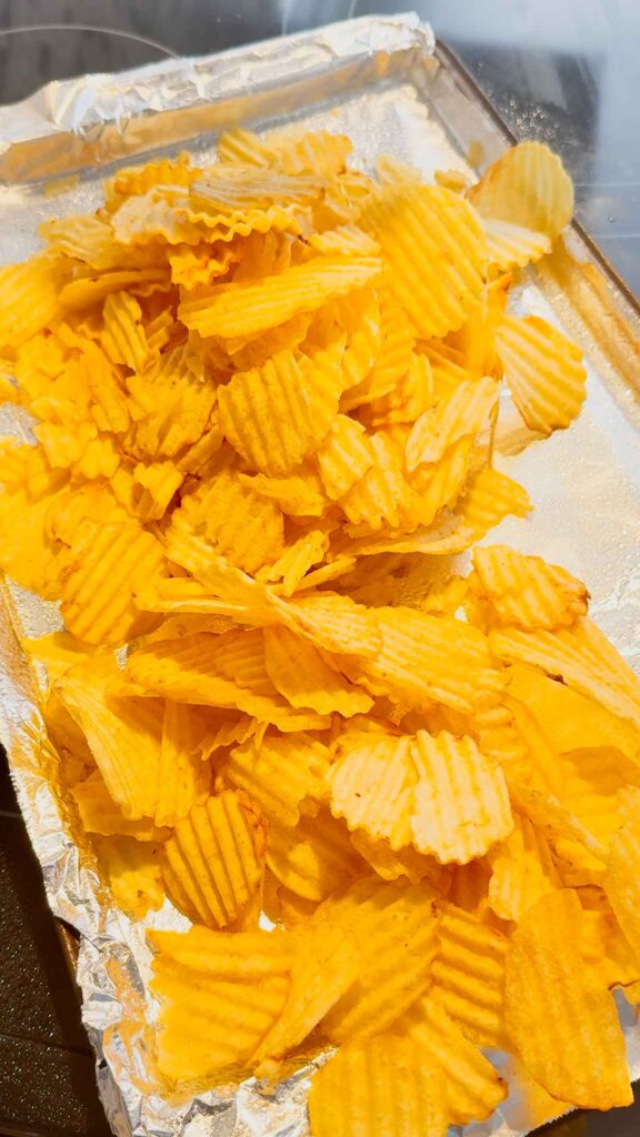 ruffled potato chips on a foil lined baking sheet