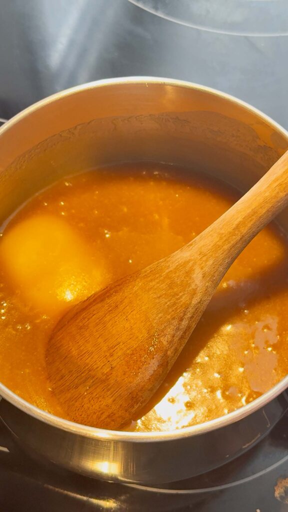 butter and brown sugar mixture cooking in a saucepan