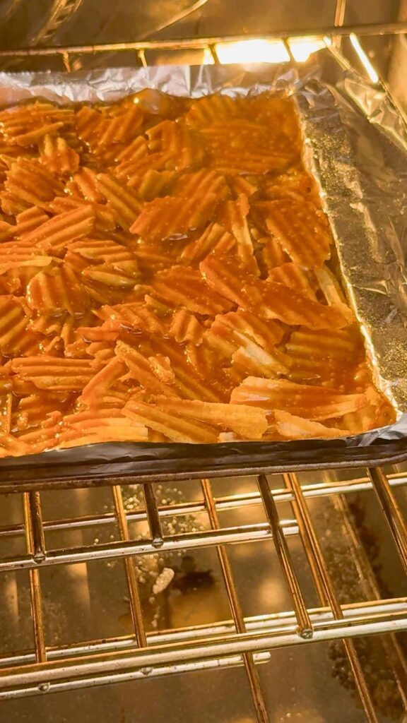 toffee coated potato chips on a baking sheet in the oven