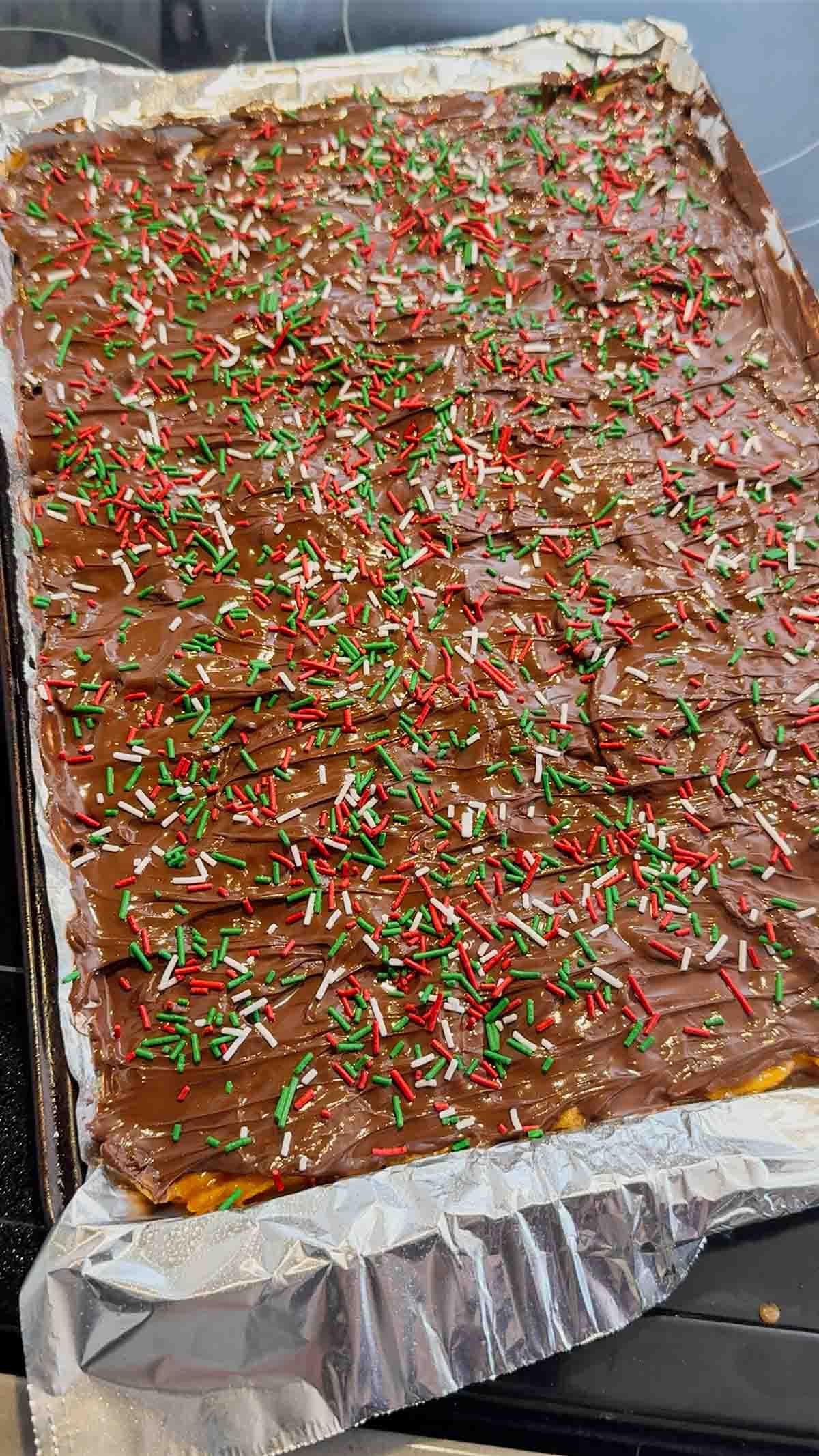 red, white and green Christmas sprinkles on top of Christmas Crack