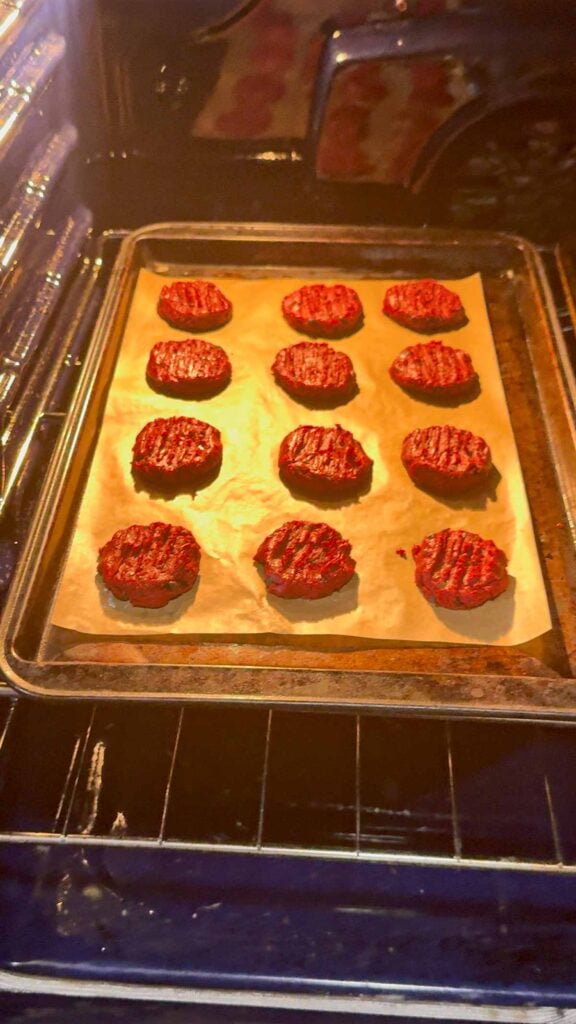 red velvet shortbread cookies on a baking sheet in the oven