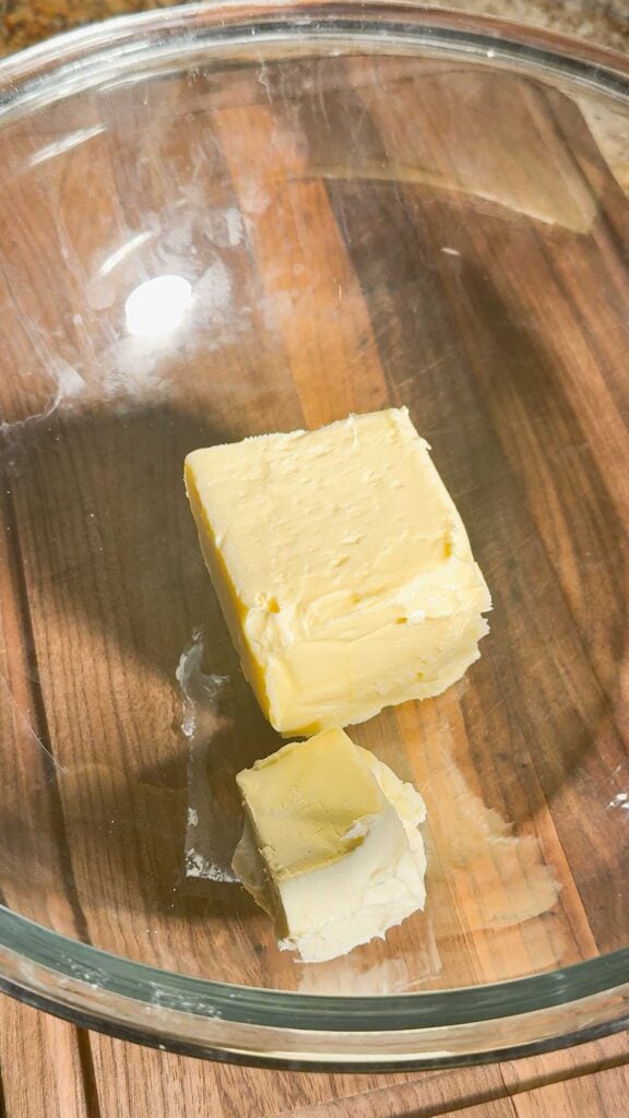softened butter and cream cheese in a glass mixing bowl