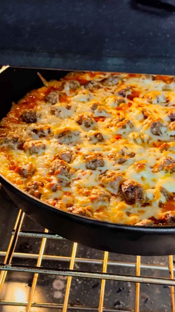 meatballs sup dip baking in a cast iron skillet in the oven