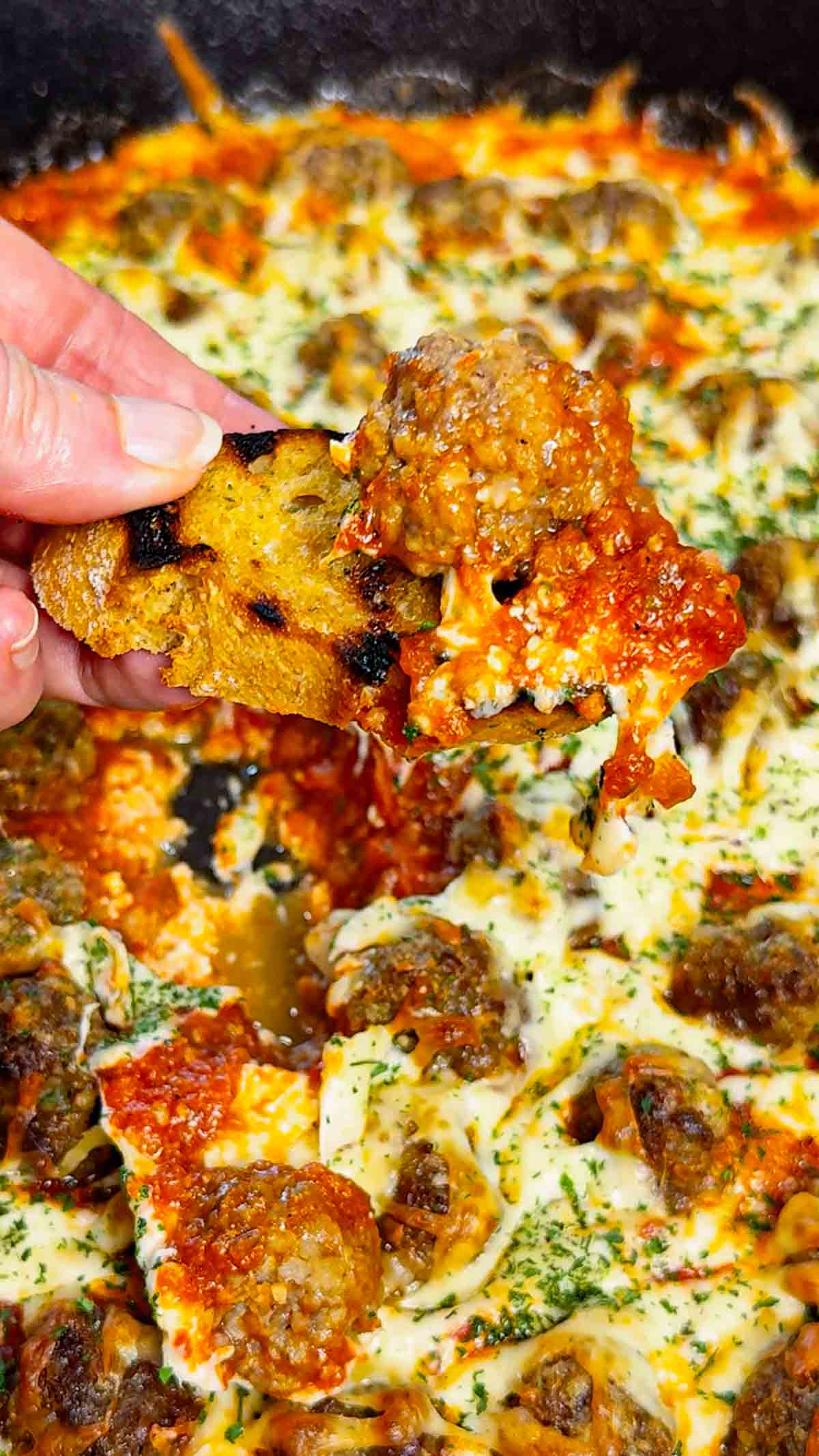 This Meatball Sub Dip is everything you love about a classic meatball sub, baked into a hot, cheesy skillet dip that’s perfect for sharing. Loaded with homemade tiny meatballs, creamy ricotta, rich pasta sauce, and plenty of shredded mozzarella, this easy baked dip comes out bubbly, melty, and packed with hearty Italian flavor. Serve it with sliced, toasted baguette for dipping to make every bite taste just like a warm, cheesy meatball sub—perfect for game day, parties, or any casual get-together.